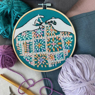 completed crochet embroidery kit featuring a crochet quilt