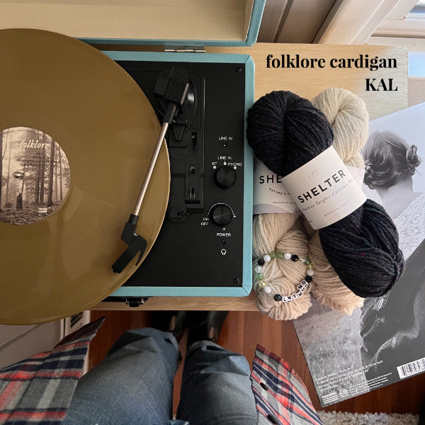 Taylor Swift album with yarn for Folklore cardigan