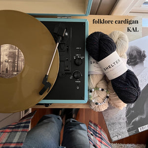 Taylor Swift album with yarn for Folklore cardigan