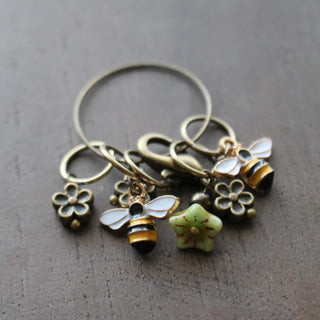 close up of bee and bloom stitch markers