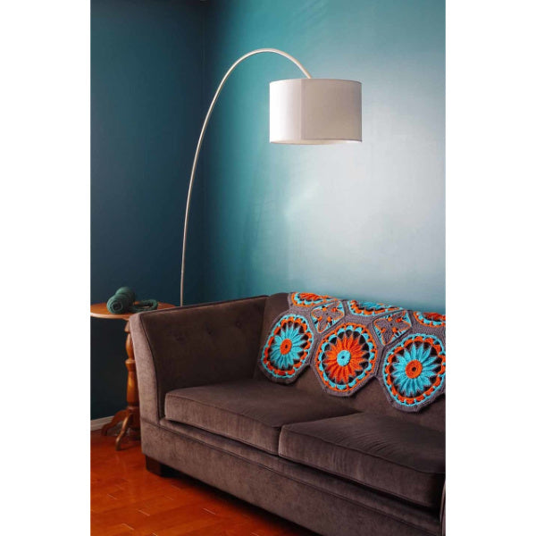 crocheted daisy afghan on a sofa