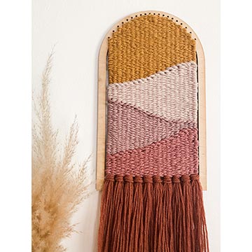 example of arch loom hanging on wall in warm colors