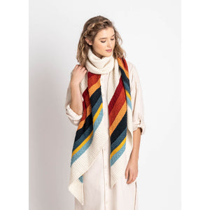 woman wearing the gresham shawl in rainbow colors