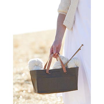 Woman holding yarn and needles in Cocoknits Kraft Caddy