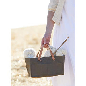 Woman holding yarn and needles in Cocoknits Kraft Caddy