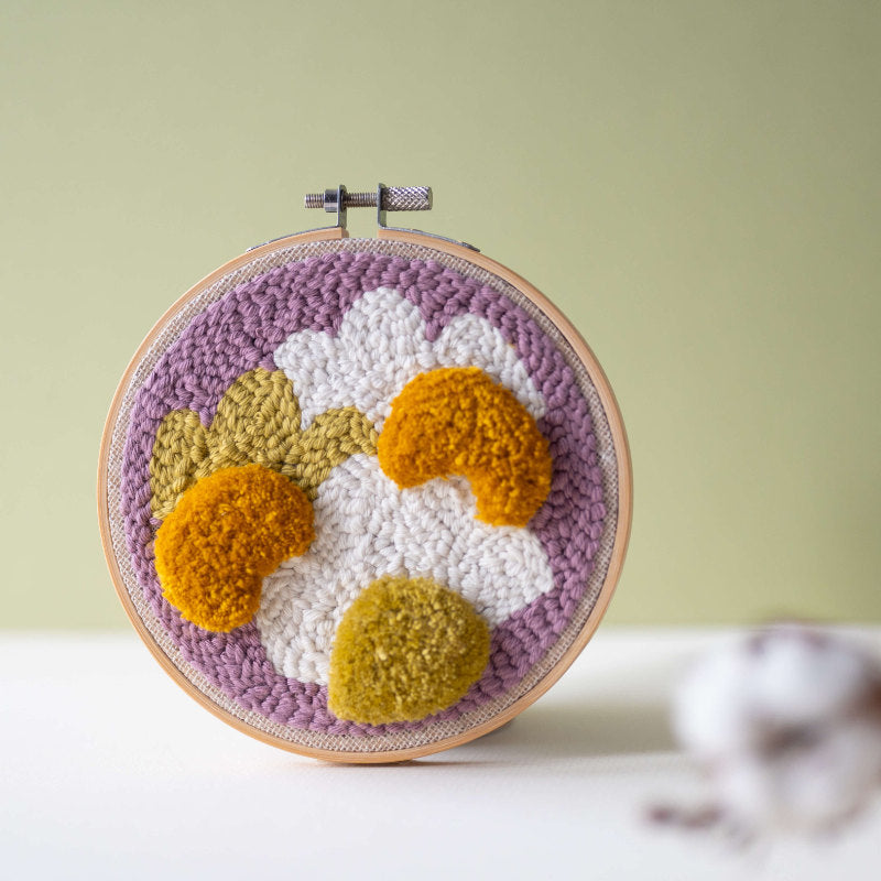 completed tufting and punch needle kit in an embroidery hoop