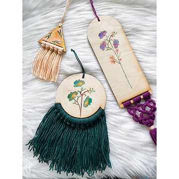 examples of completed painted looms with tassels