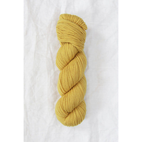 Quince chickadee sport weight yarn in carries yellow