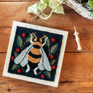 Spring Bee Punch Needle kit with a wood background