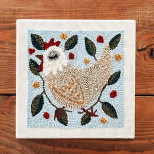 Chicken punch needle kit with a wood background