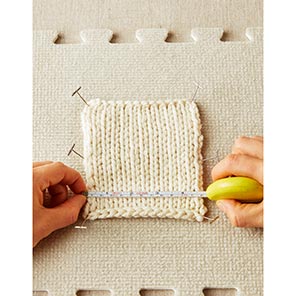 Knitted Swatch on blocking mat with the Cocoknits Pebble Tape Measure