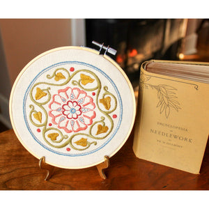 arcadian rose embroidery kit on table