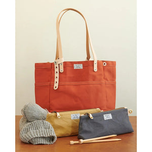 artifcat knitting bag with knitting pouches and yarn